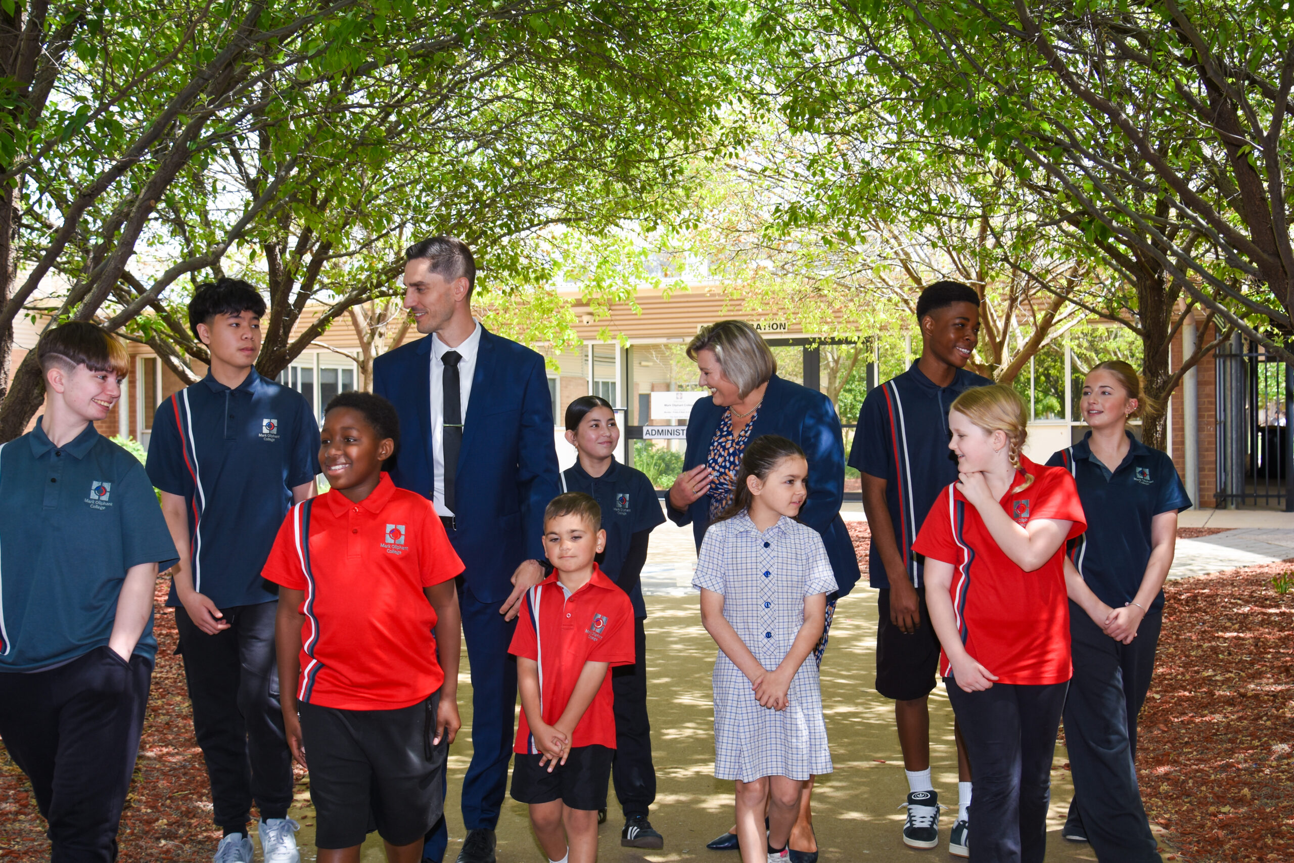 Students from across year levels standing with staff in the school grounds