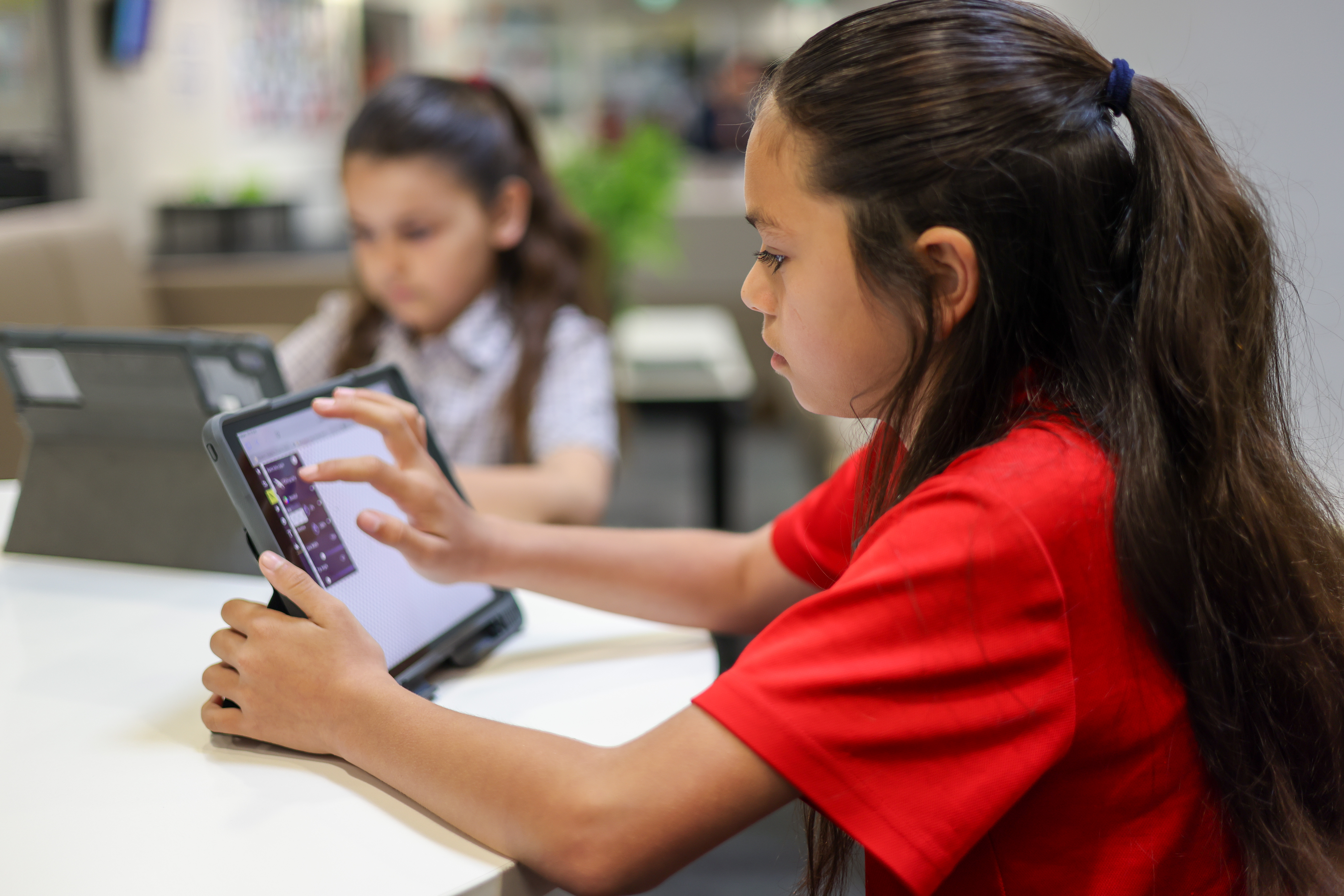 Primary students working together on an iPad