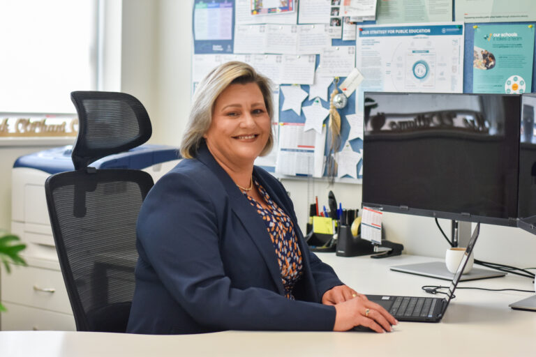 Kerry Williams, Principal of Mark Oliphant College, working at a desk