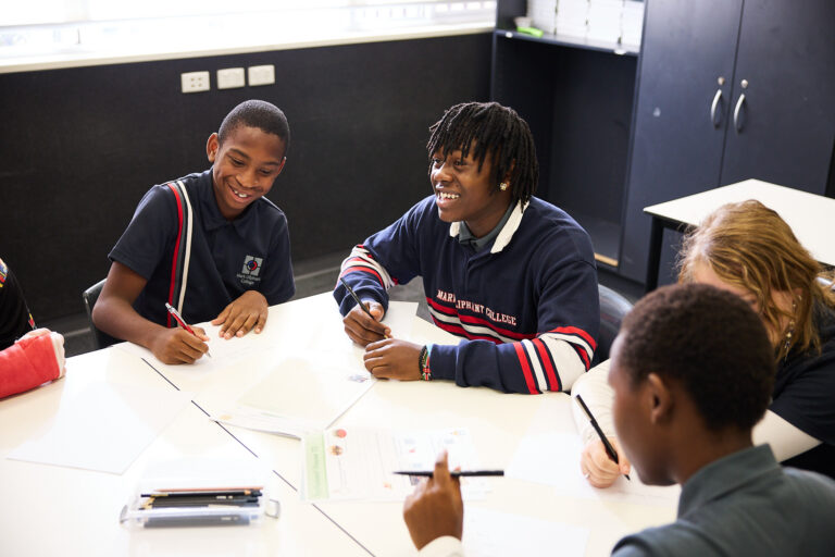 Middle years students working together at desks in the classroom