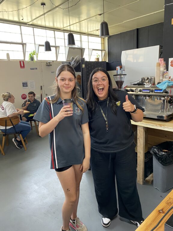 Student and staff member in the school cafe