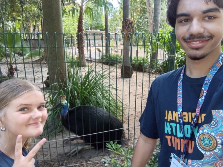Students at a wildlife park in front of a cassowary enclosure