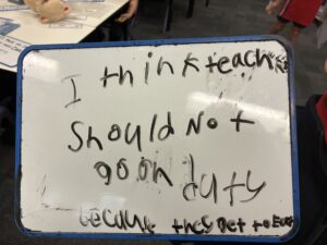 Student whiteboard reading 'I think teachers should not go on duty'
