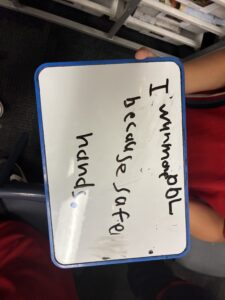 Student whiteboard about Positive Behaviour for Learning and using safe hands