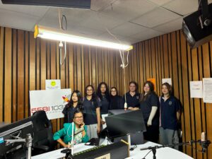 Year 9 Indonesian students with a presenter in the 5EBI 103.1 FM studio