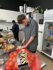 Student preparing vegetables in the HOPE Street kitchen