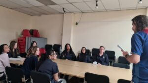 Year 9 Indonesian students being briefed in a meeting room at the radio station