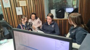 Year 9 Indonesian students at the radio desk with a presenter