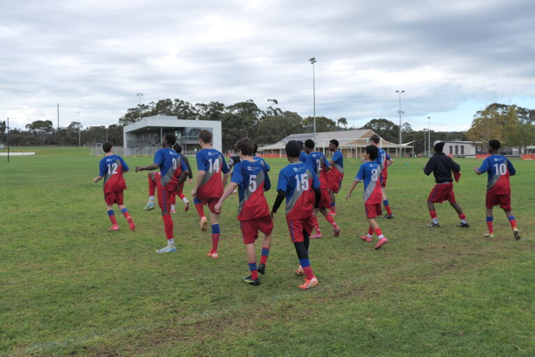 Year 9/10 boys knockout soccer team walking onto the field