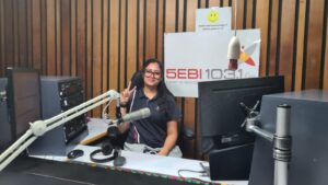 Year 9 student presenting at the microphone in the radio studio