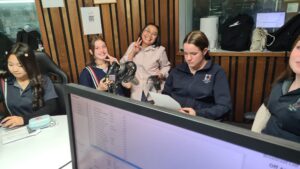 Year 9 Indonesian students reading a script in the radio studio