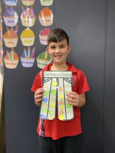 Year 1D student holding their patterned Pattern Pants artwork